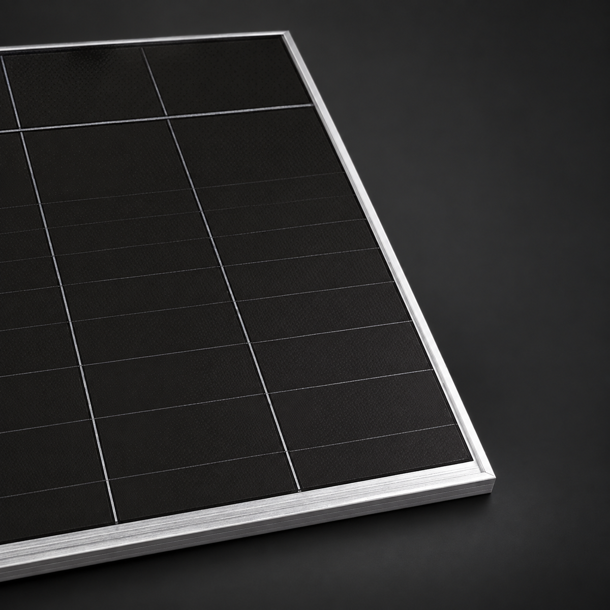 Close-up of AIKO Stellar silver-frame solar panel on a dark studio background